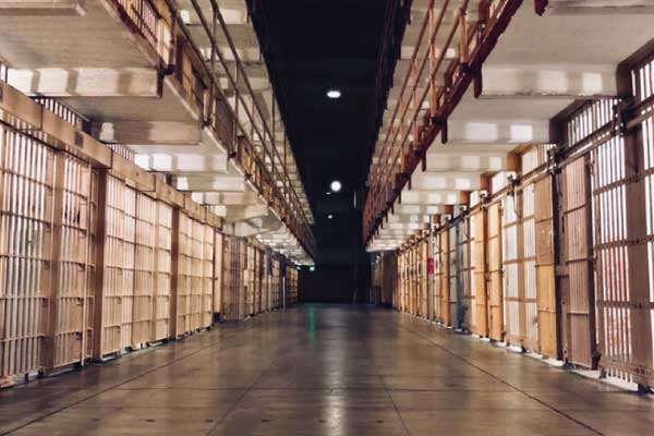 Prison walkway with empty prison cells