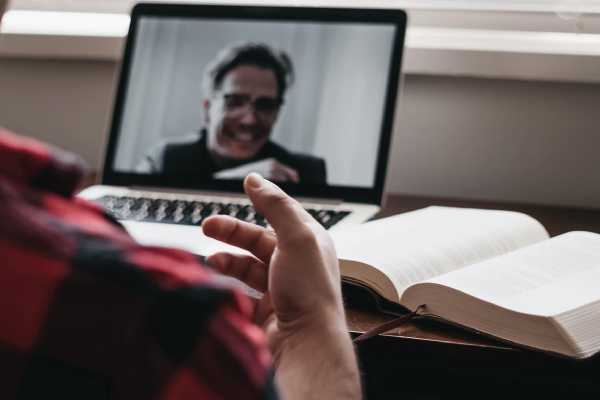 laptop screen showing male employee in a zoom call interview