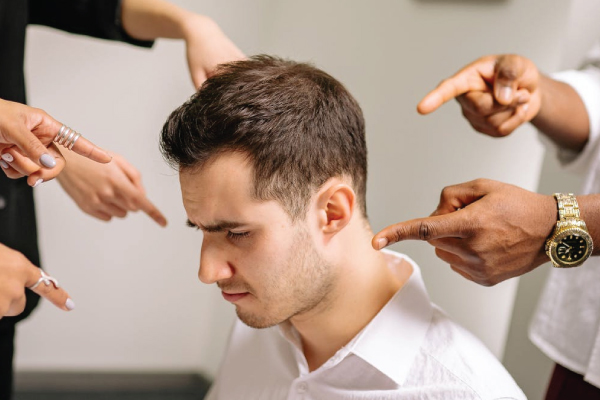 Man being put down by coworkers