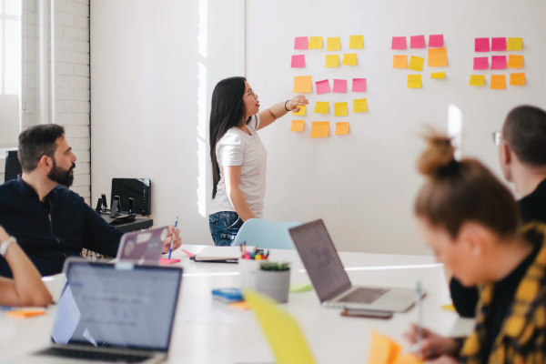 female recruiter presenting HR strategies during team meeting