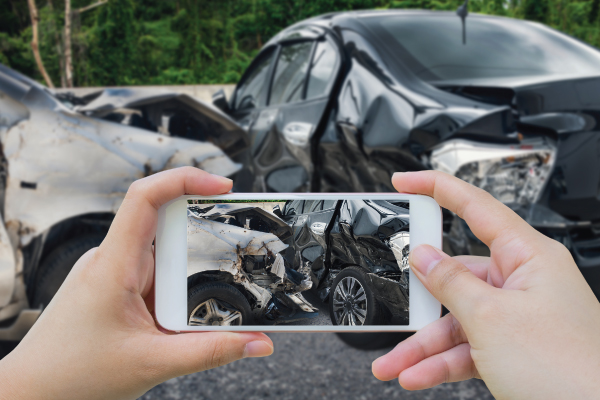 Person taking photo of car accident